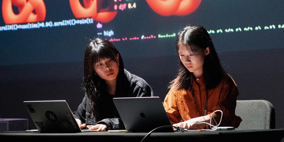 Two female students coding