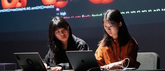 Two female students coding