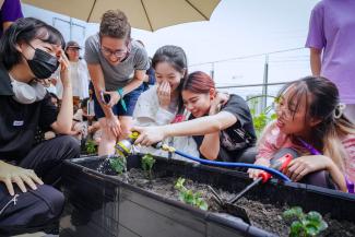 A group of students watering plants