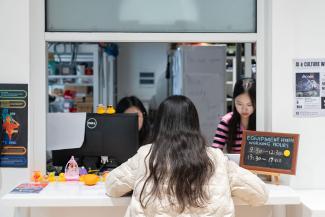 A student at the Equipment Room window