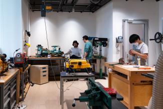 A group of students working on wood