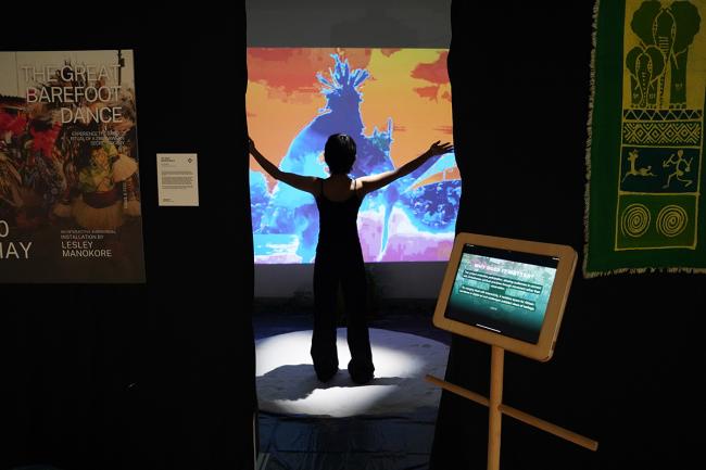 Shot of Participant from the entrance of the installation, stepping onto the sacred ground and performing a dance