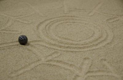 A black circle shape robot following shape on sand