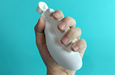 A hand squeezing an white object